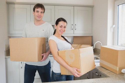 Removal team carrying furniture through a residential property entrance